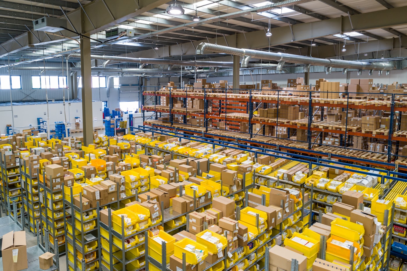 Bright modern warehouse with stacked goods