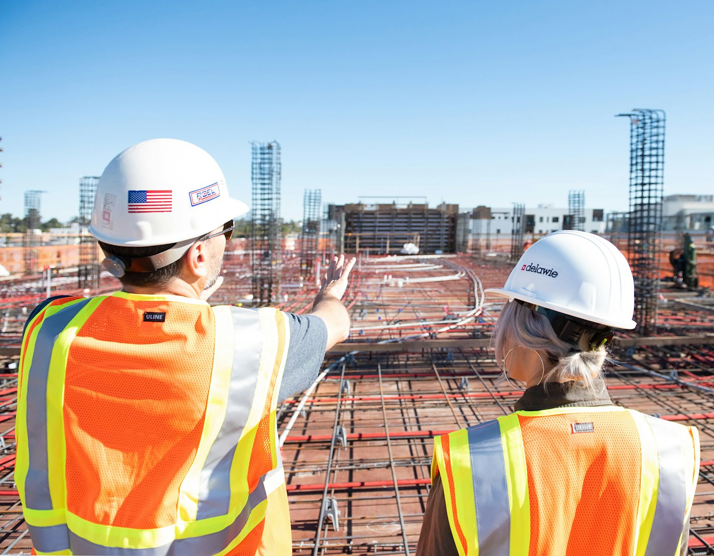 Two engineers reviewing plans on a construction site