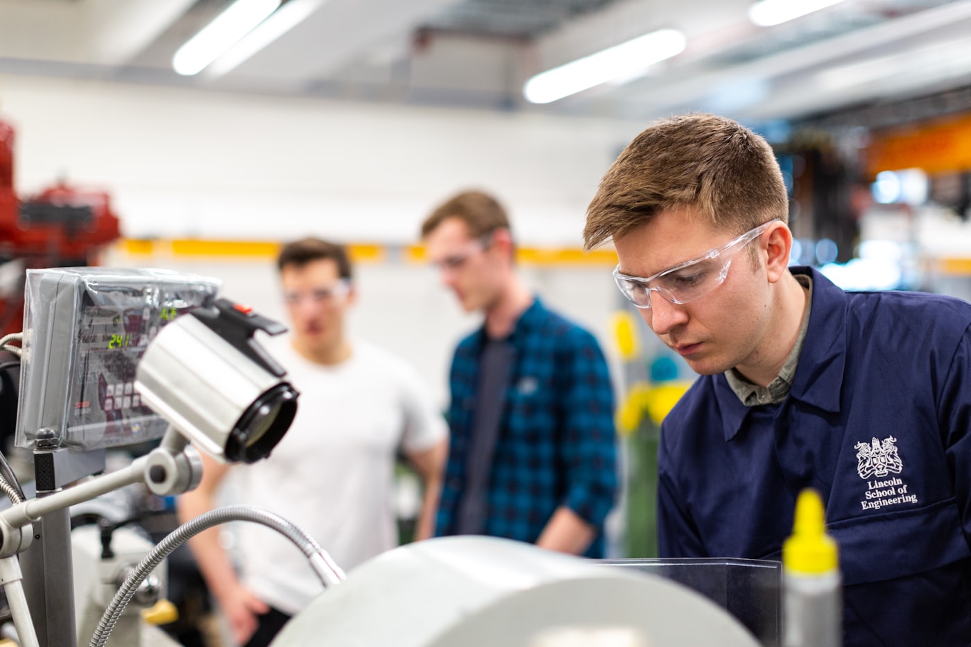 Engineering students working in a mechanical workshop