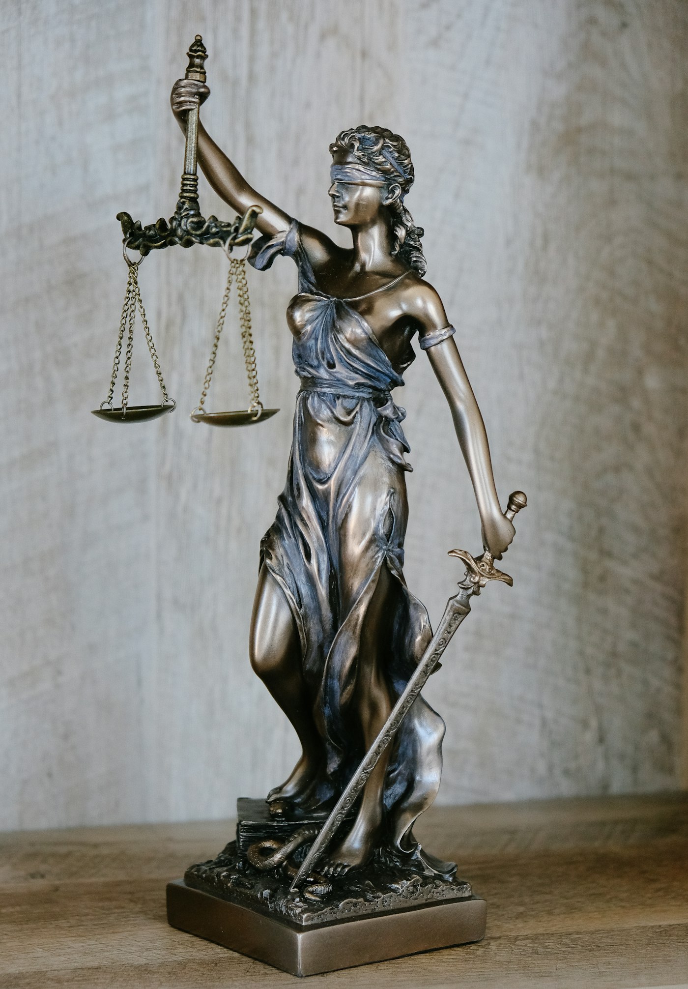 Bronze statue of Lady Justice holding scales