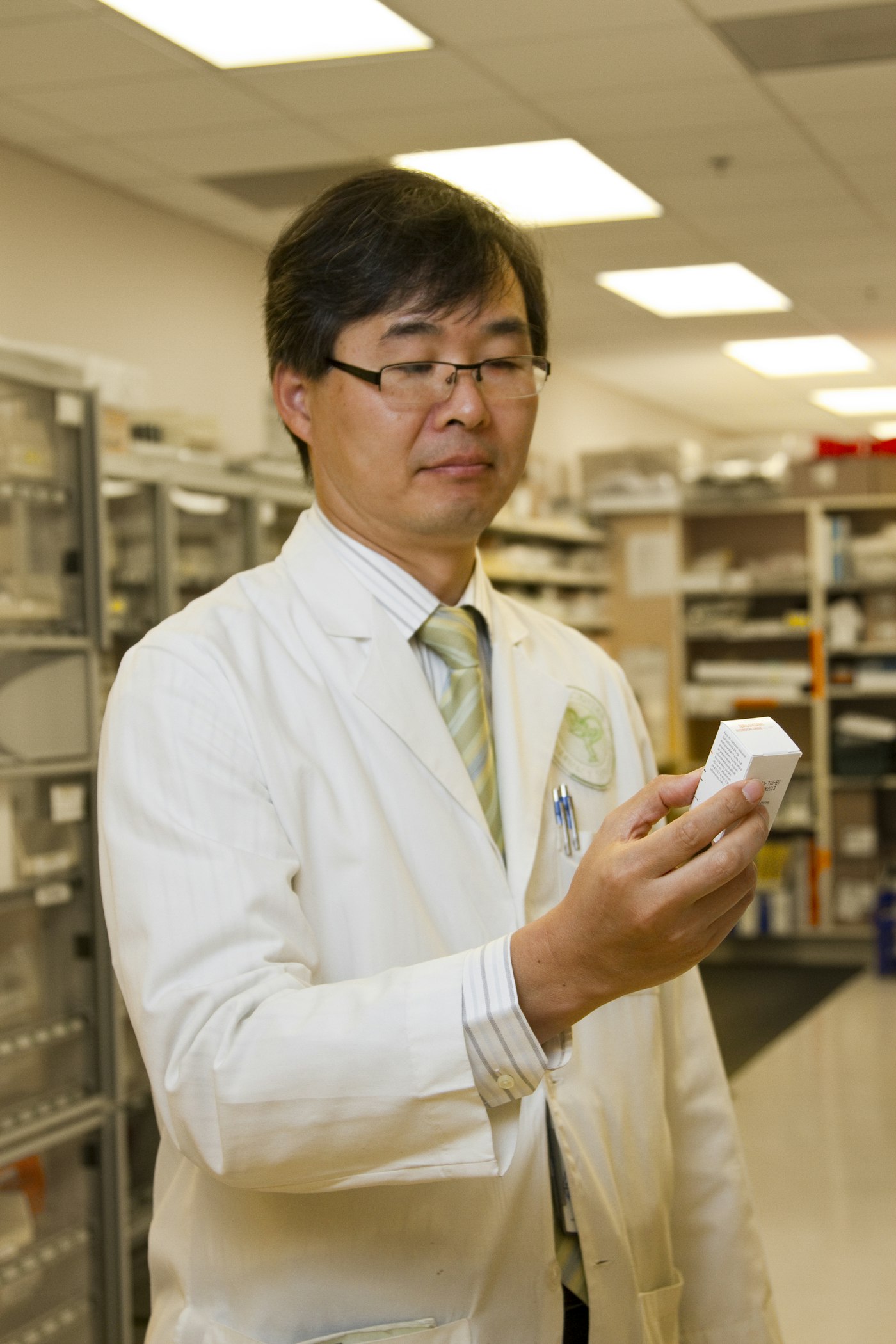 Pharmacist reading a medicine package