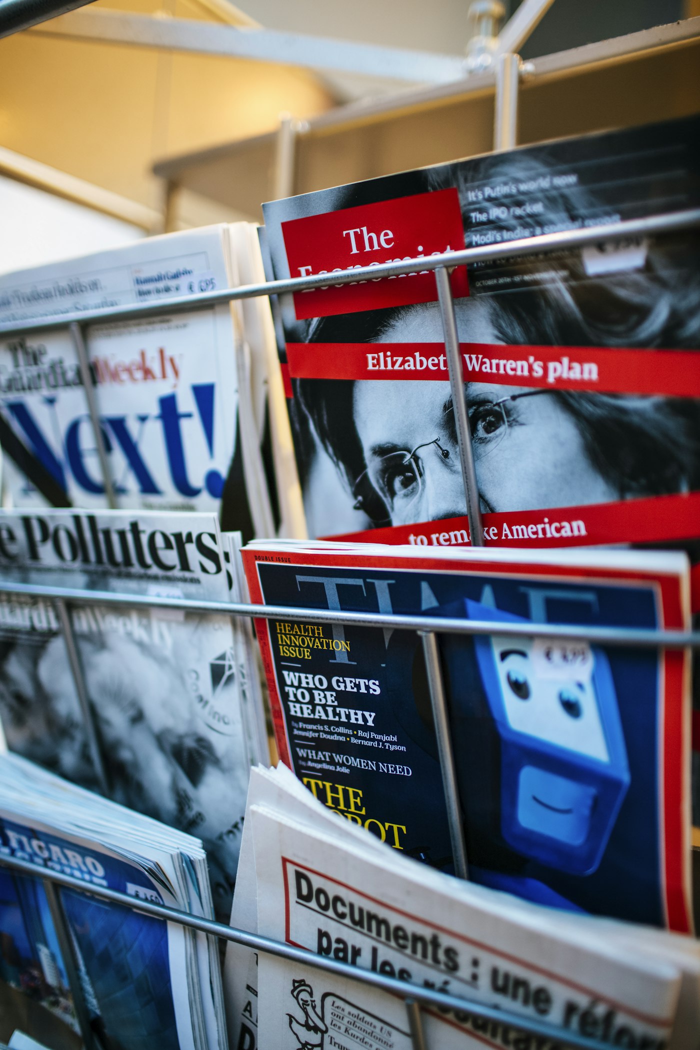 Magazines and newspapers on a news-stand rack